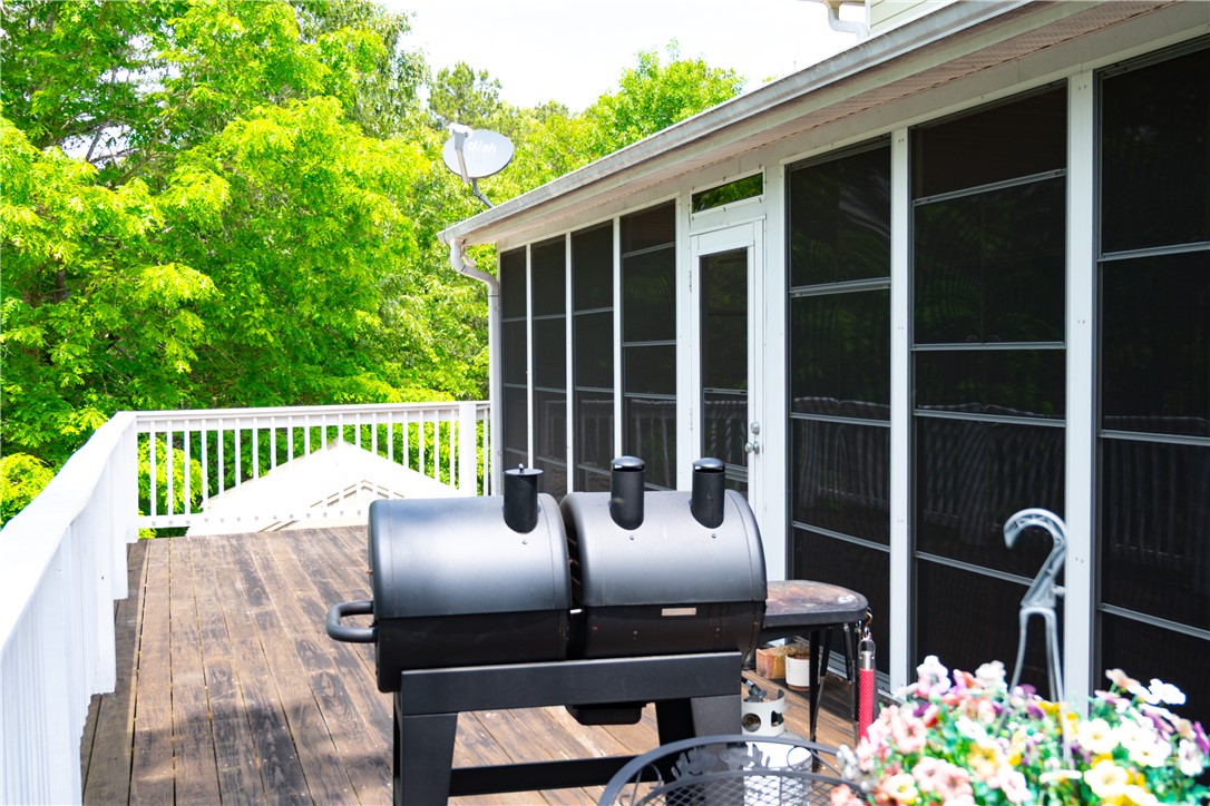 608 McKinney Way Westminster, SC 29693 - Photo 23 of 34 A spacious wooden deck with a grill and a screened-in porch offers tranquil outdoor living.
