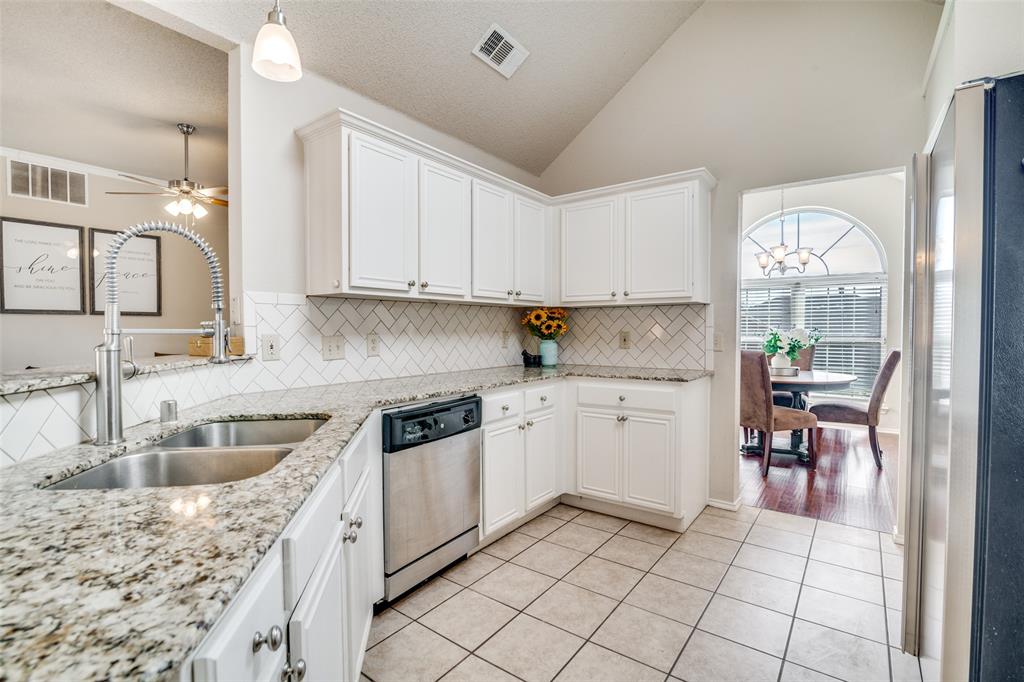 4201 Crystal Lane Garland, TX 75043 - Photo 12 of 33 a kitchen with granite countertop a sink a stove and cabinets