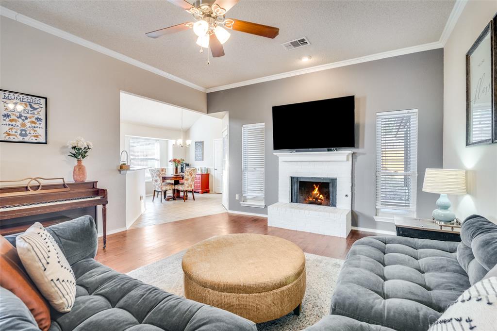 4201 Crystal Lane Garland, TX 75043 - Photo 2 of 33 a living room with furniture a flat screen tv and a fireplace