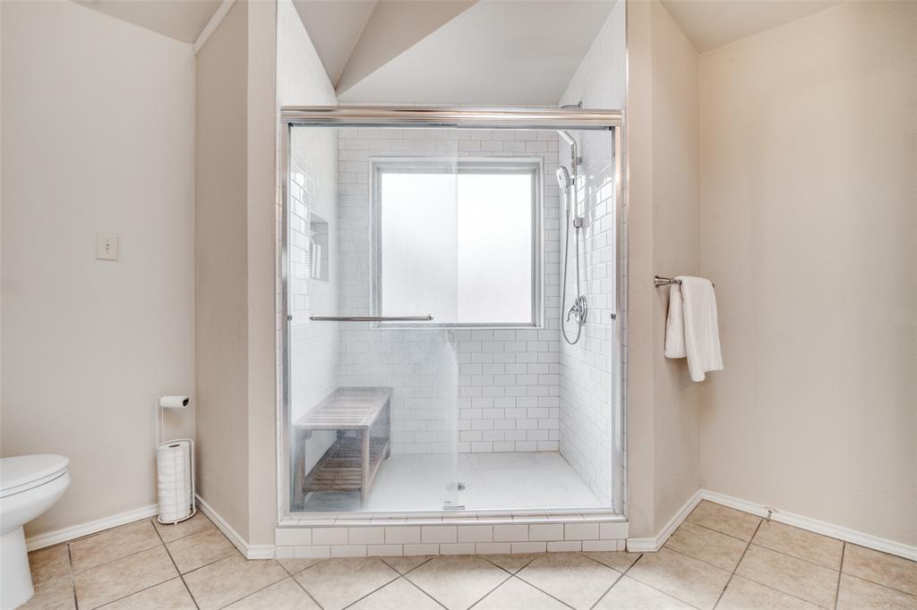 4201 Crystal Lane Garland, TX 75043 - Photo 22 of 33 a bathroom with a glass shower door