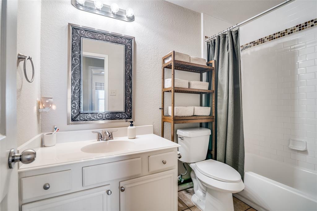 4201 Crystal Lane Garland, TX 75043 - Photo 25 of 33 a bathroom with a sink toilet vanity and shower