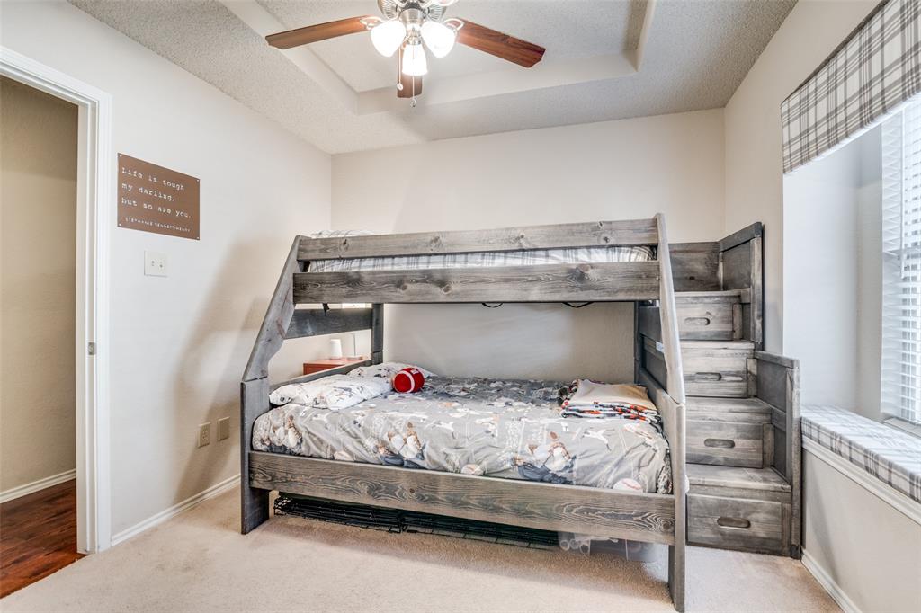 4201 Crystal Lane Garland, TX 75043 - Photo 26 of 33 a bedroom with a bed and a chandelier