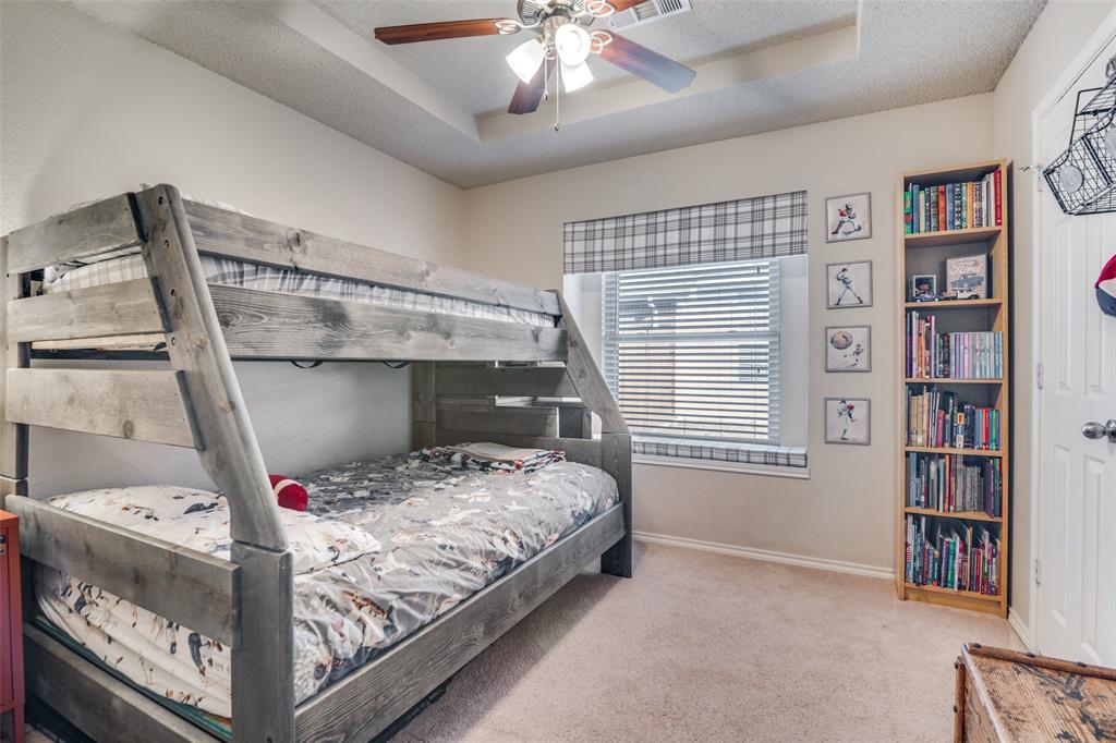4201 Crystal Lane Garland, TX 75043 - Photo 27 of 33 a bed sitting in a bedroom next to a book shelf