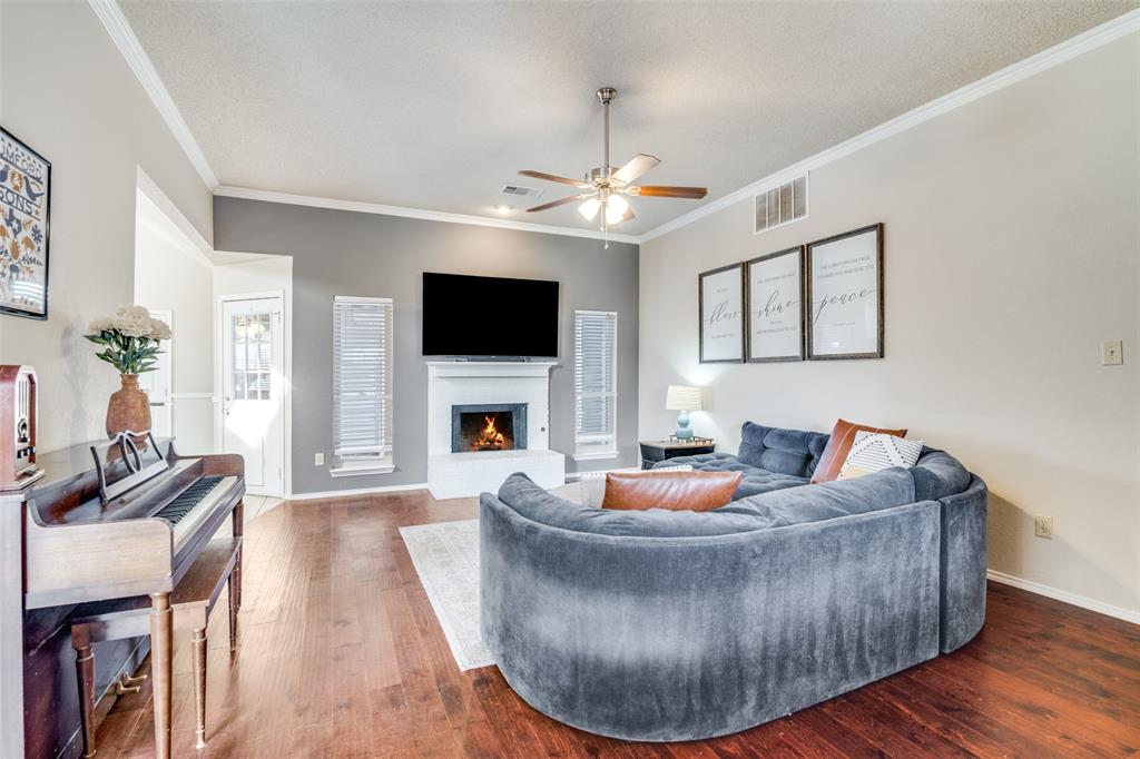 4201 Crystal Lane Garland, TX 75043 - Photo 9 of 33 a living room with furniture a fireplace and a flat screen tv