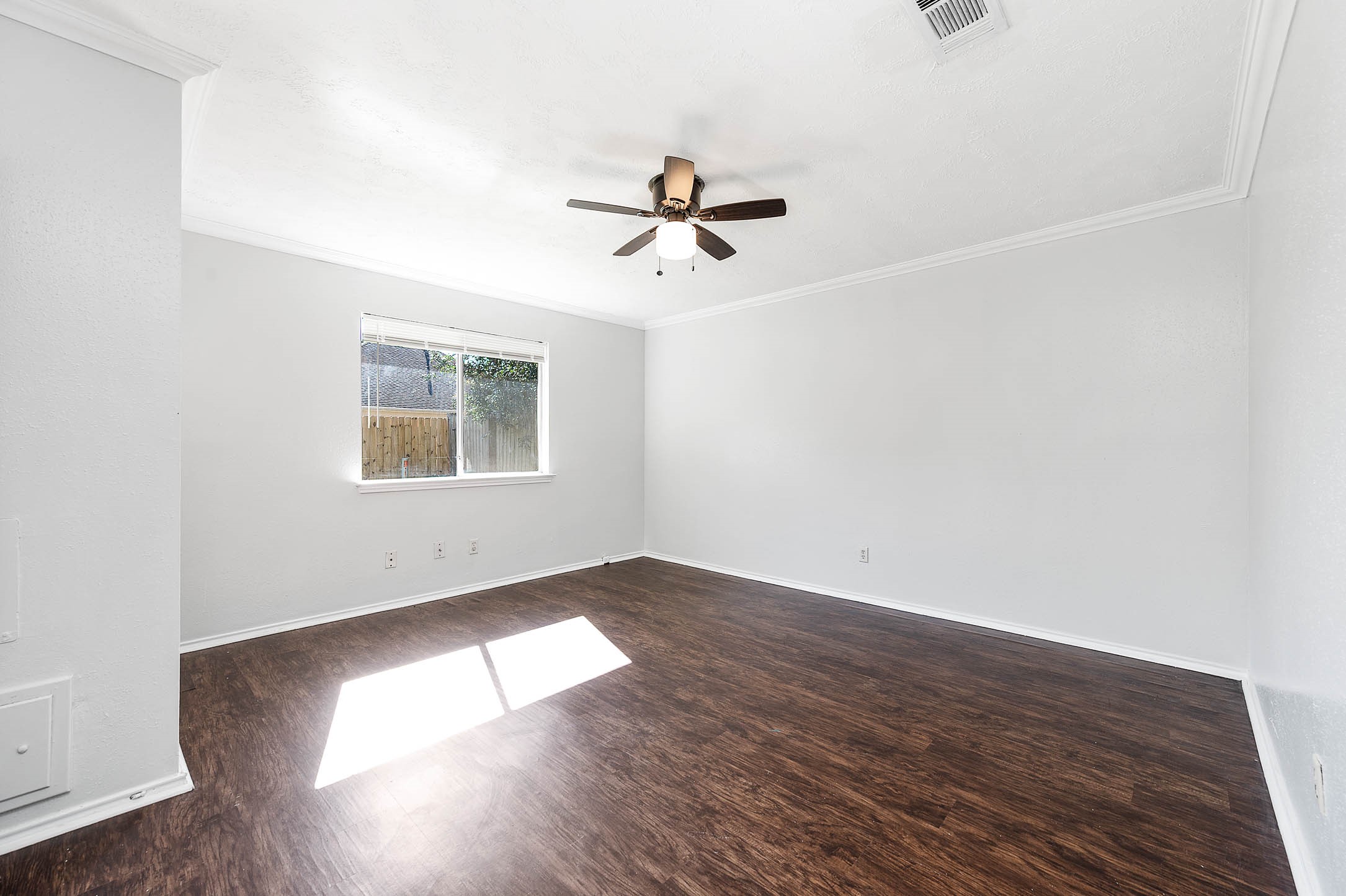 3423 Nutwood Lane Spring, TX 77389 - Photo 16 of 20 an empty room with wooden floor ceiling fan and windows