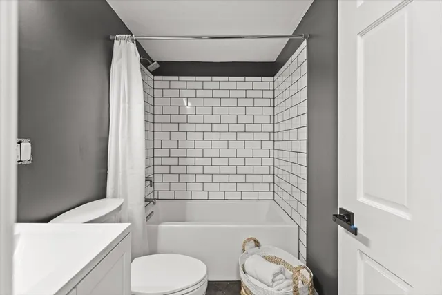 a bathroom with a toilet and a bathtub