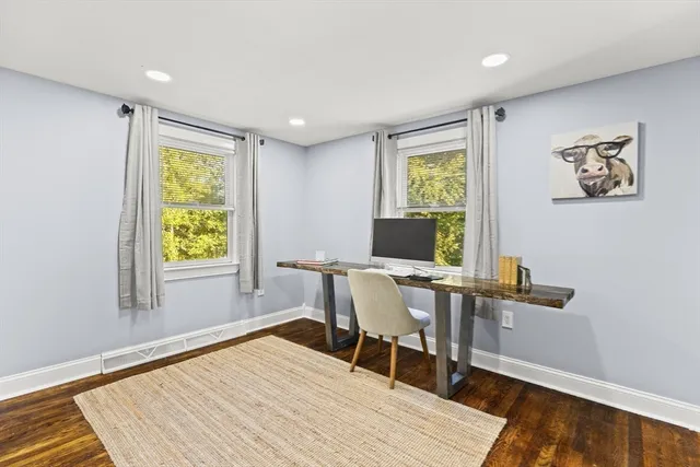 a workspace with wooden floor and a window
