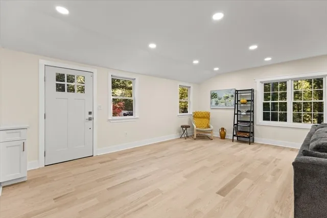 a view of a livingroom with a large window and lounge chair