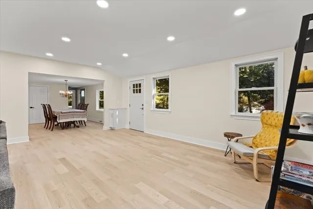 a view of an empty room with furniture and windows