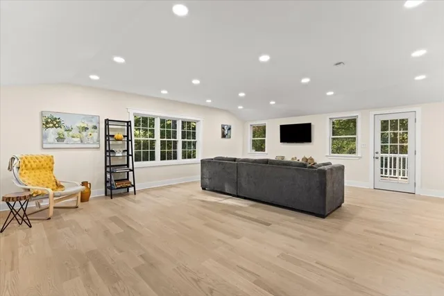 a living room with furniture pool table and a flat screen tv