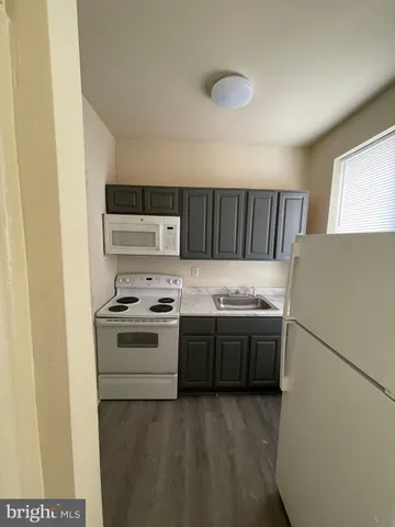 a kitchen with a stove top oven and sink