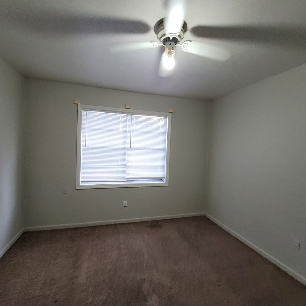 6640 Playfield Drive Columbus, GA 31907 - Photo 9 of 11 an empty room with a window and a fan