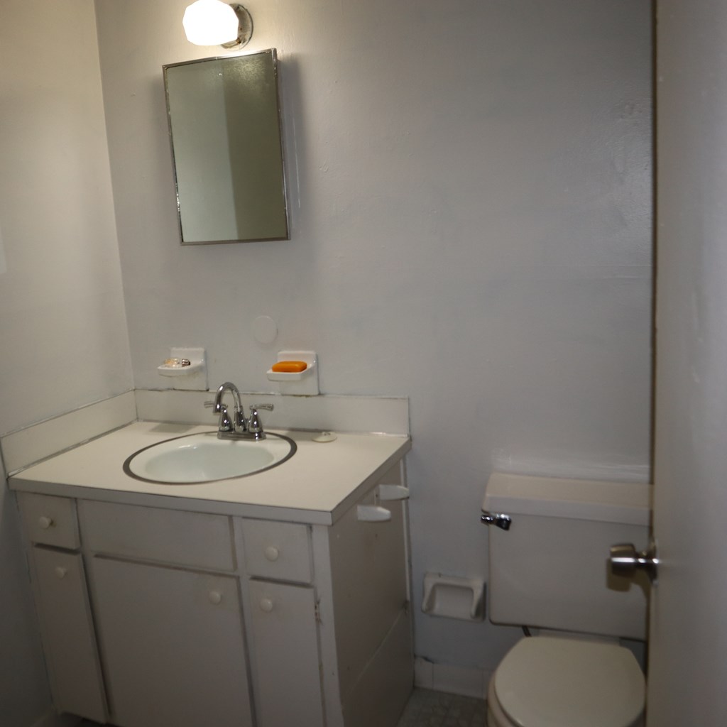 6640 Playfield Drive Columbus, GA 31907 - Photo 10 of 11 a bathroom with a toilet sink and mirror