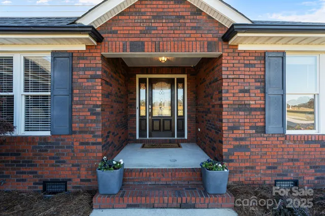 a front view of a house with plants
