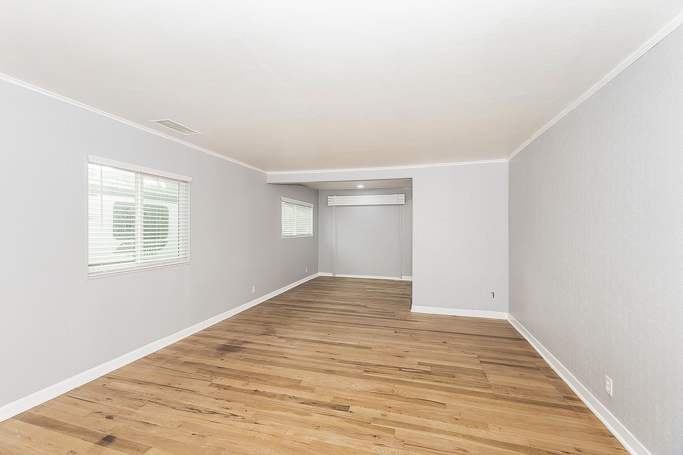 422 North Pine Street Madera, CA 93637 - Photo 5 of 54 a view of empty room with wooden floor and fan