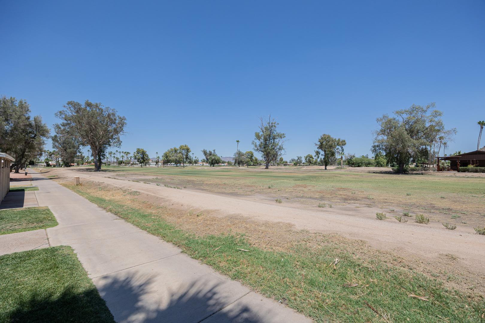 609 South Power Road, Unit 338 Mesa, AZ 85206 - Photo 21 of 24 a view of dirt road with a building in the background