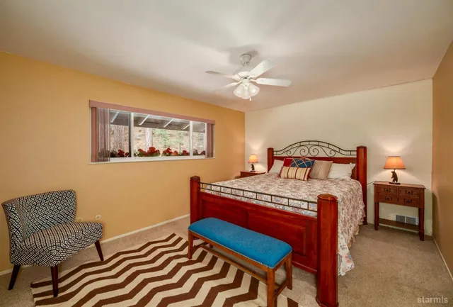 a bedroom with two beds and a window