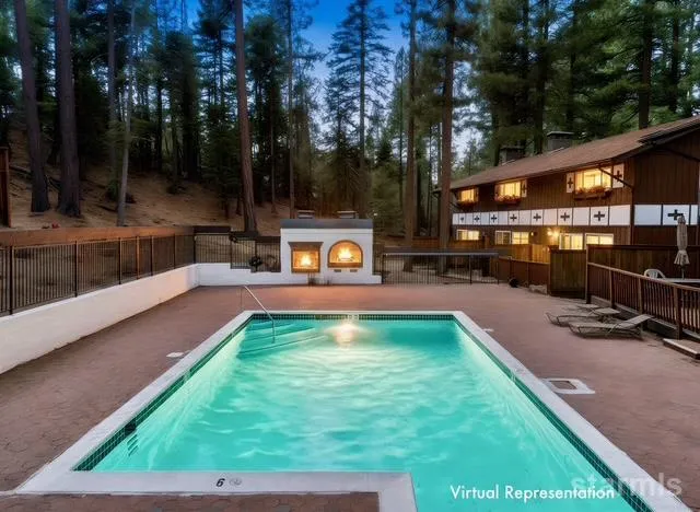 a view of a house with swimming pool and sitting area