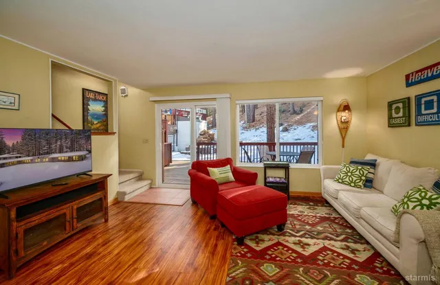 a living room with furniture and a floor to ceiling window