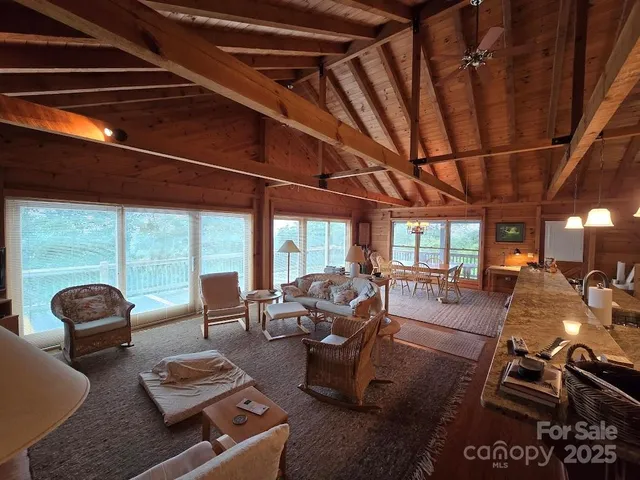 a living room with furniture floor to ceiling windows and floor to ceiling window