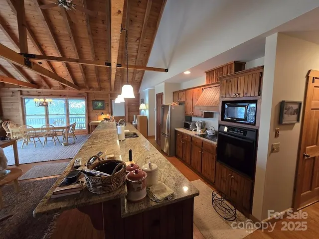 a kitchen with stainless steel appliances granite countertop a stove refrigerator and cabinets