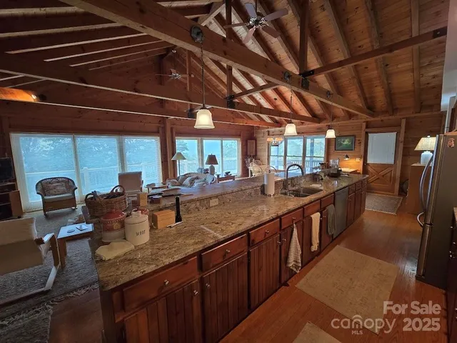 a kitchen with stainless steel appliances granite countertop a sink a counter space wooden cabinets and a sink