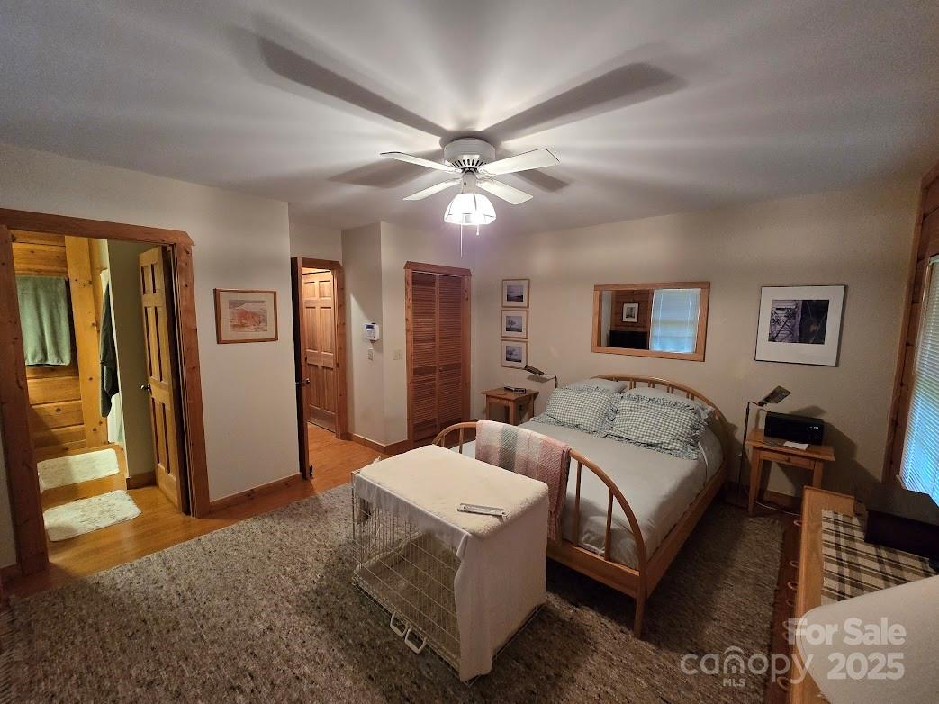 979 Wagon Road, Unit 68 Warrensville, NC 28693 - Photo 17 of 40 a bedroom with a bed and a chandelier