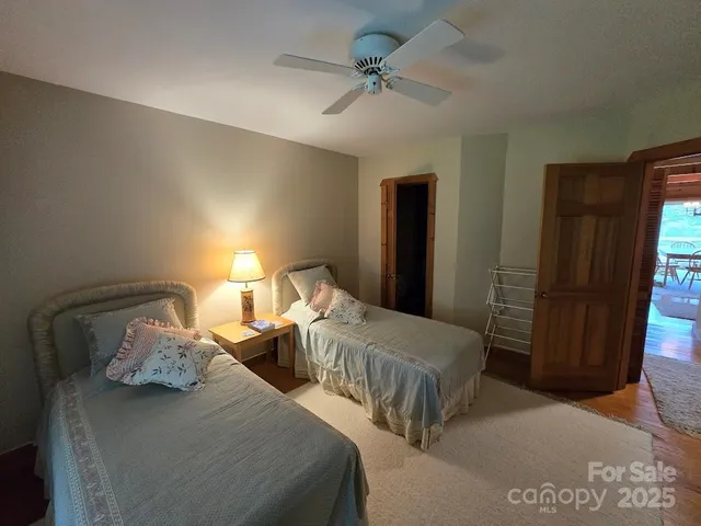 a bedroom with two beds and a chandelier