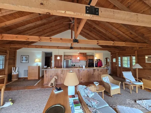 a living room with furniture and wooden floors