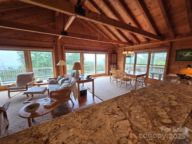 a living room with furniture a wooden floor and a large window