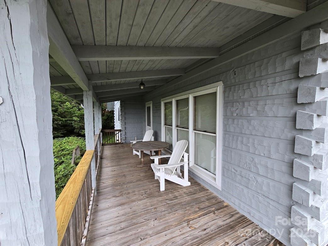 979 Wagon Road, Unit 68 Warrensville, NC 28693 - Photo 3 of 40 a view of a patio with wooden floor and iron stairs