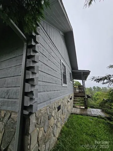 a view of stairs and yard with wooden fence