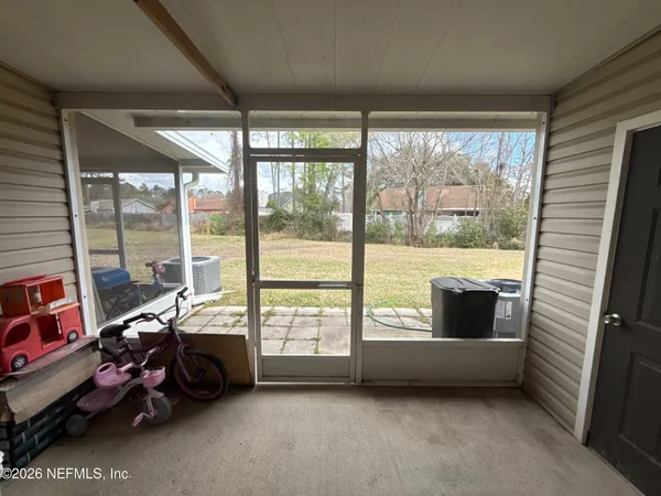 a view of room with furniture and large windows