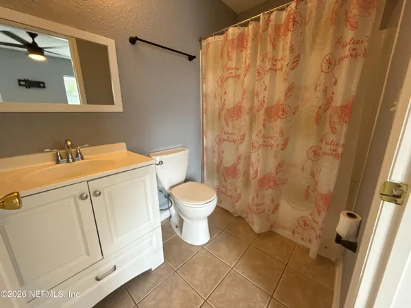 a bathroom with a toilet sink and a mirror