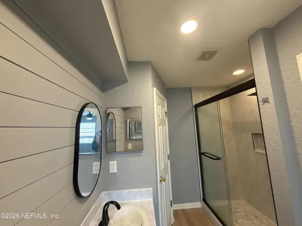 a bathroom with a glass shower door