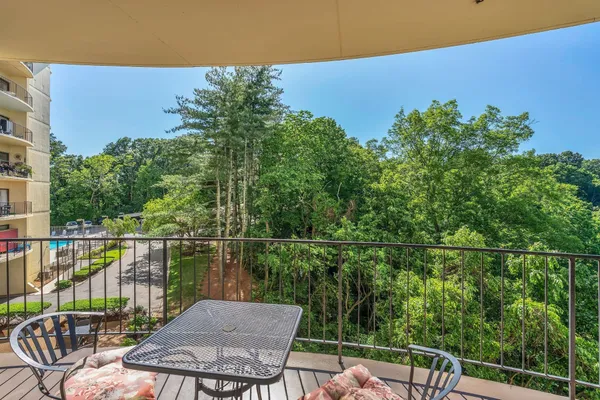 a view of balcony with chairs and wooden fence