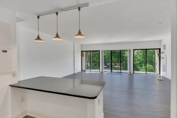 a kitchen with stainless steel appliances granite countertop a refrigerator a sink and a stove
