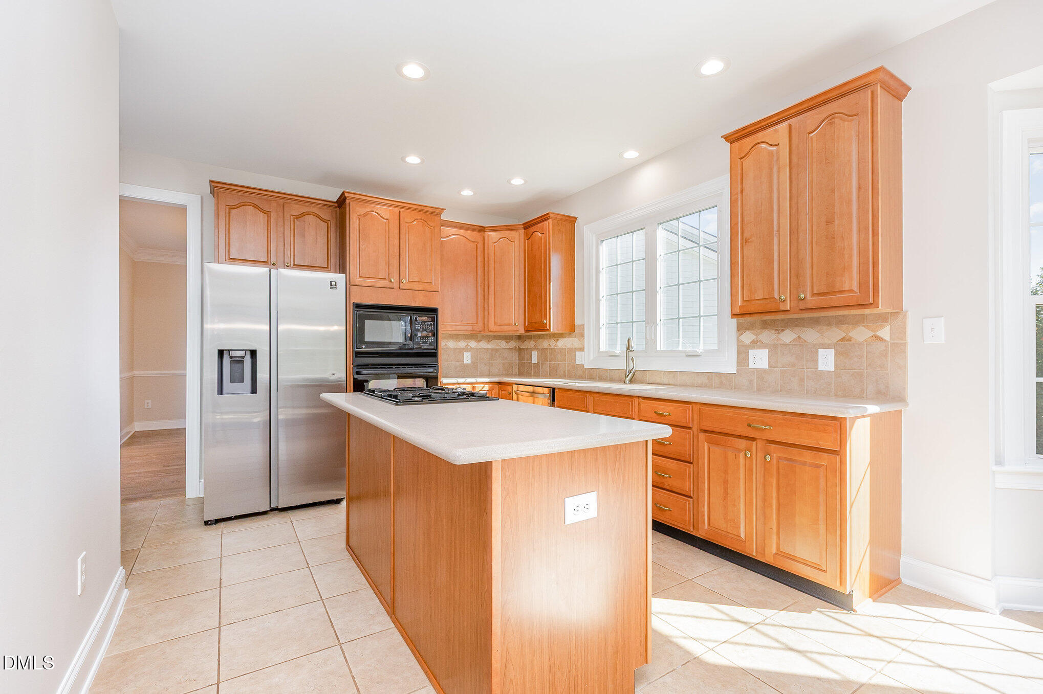 9113 Mission Hills Court Raleigh, NC 27617 - Photo 12 of 36 a kitchen with stainless steel appliances granite countertop wooden cabinets a sink and a stove