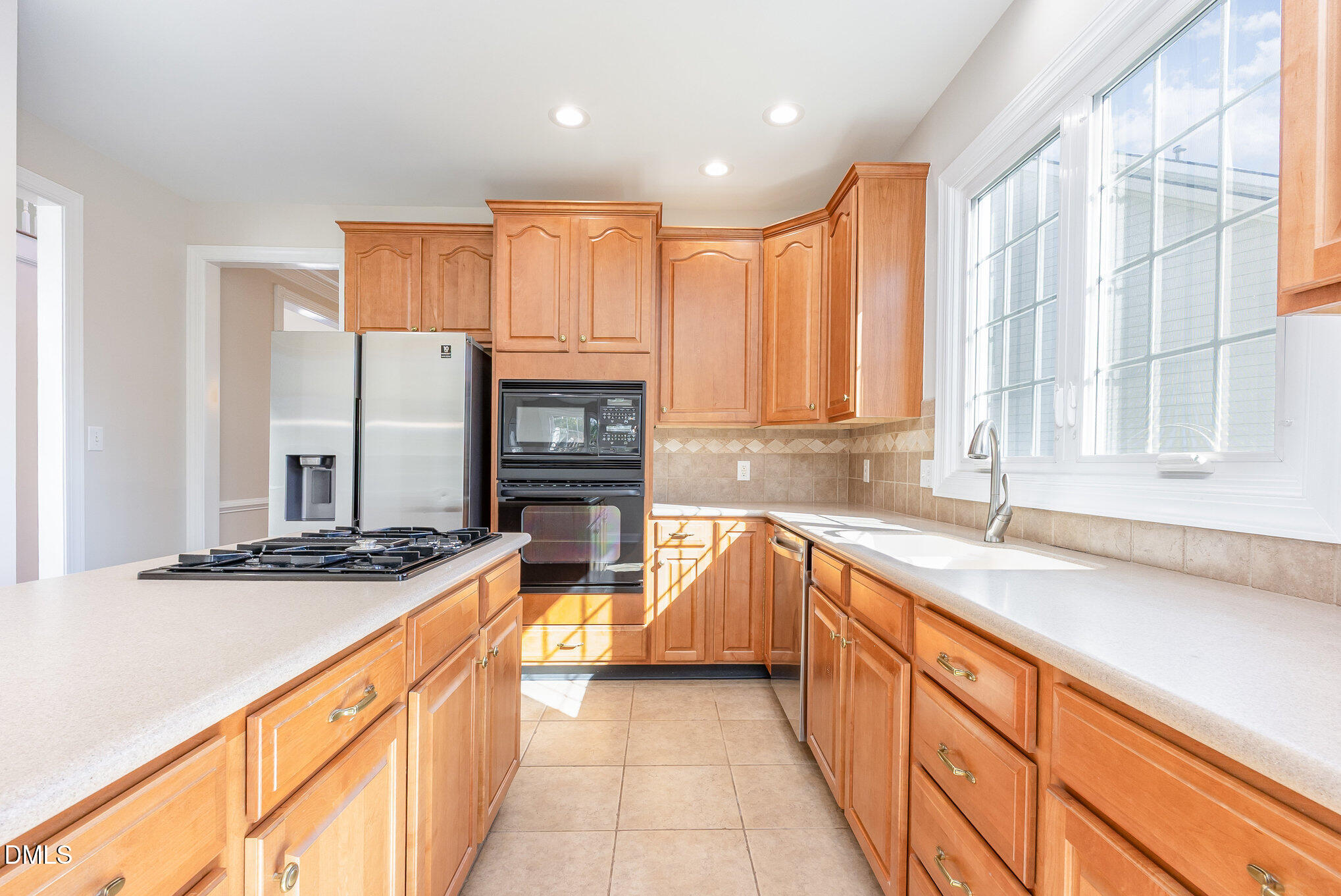 9113 Mission Hills Court Raleigh, NC 27617 - Photo 13 of 36 a kitchen with stainless steel appliances granite countertop a sink and a stove