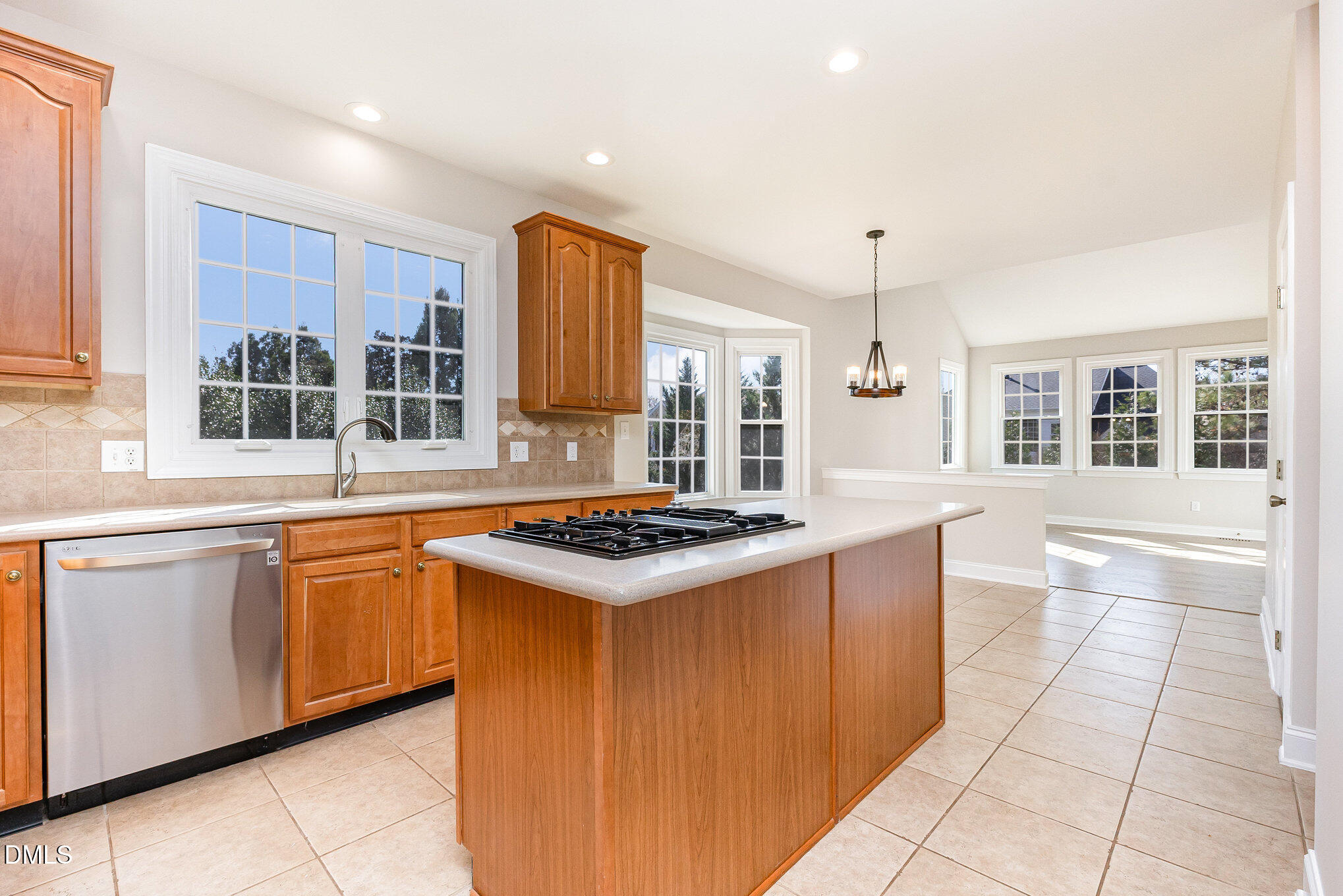9113 Mission Hills Court Raleigh, NC 27617 - Photo 14 of 36 a kitchen with stainless steel appliances granite countertop a stove a sink and a refrigerator