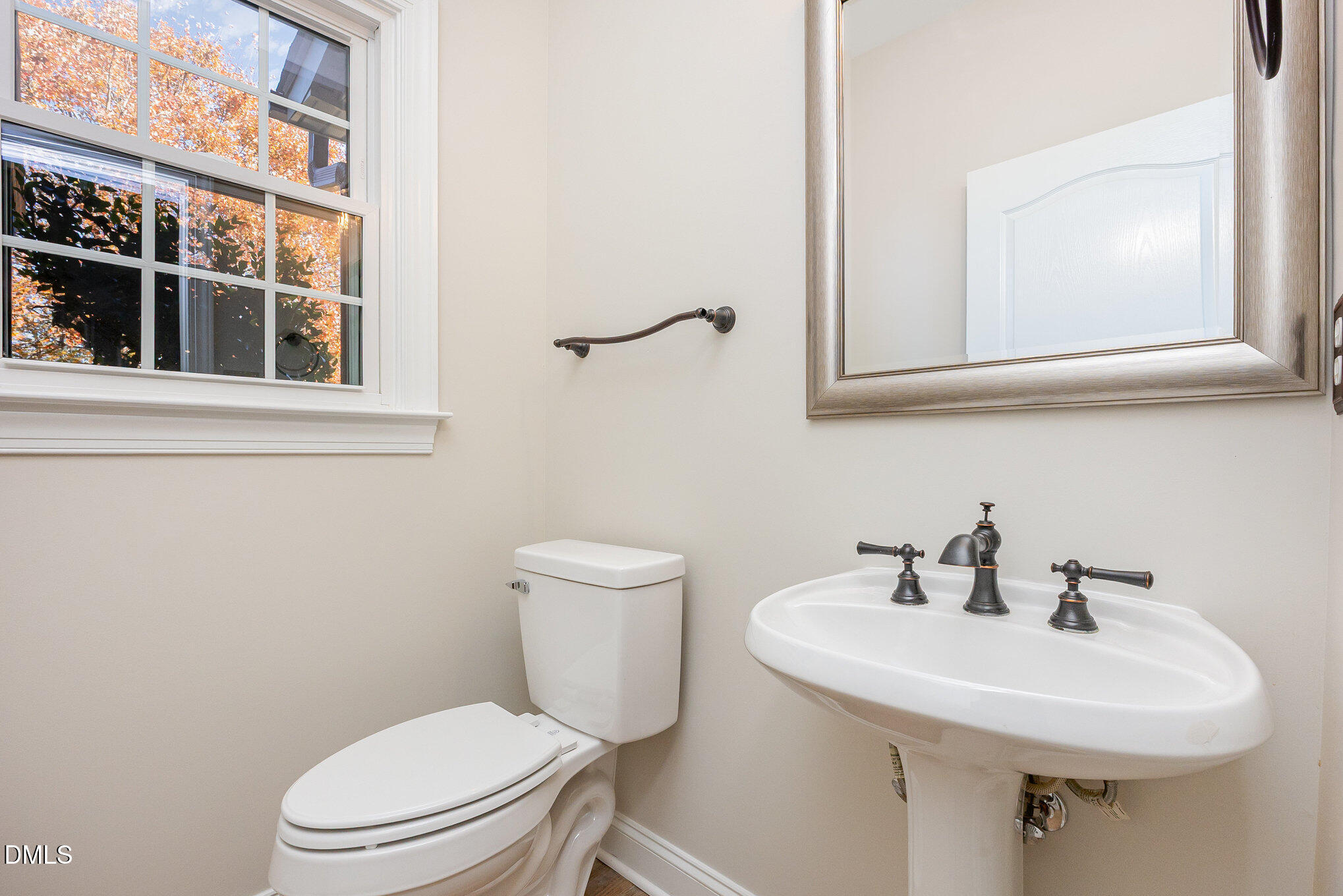 9113 Mission Hills Court Raleigh, NC 27617 - Photo 15 of 36 a white toilet sitting next to a bathroom sink