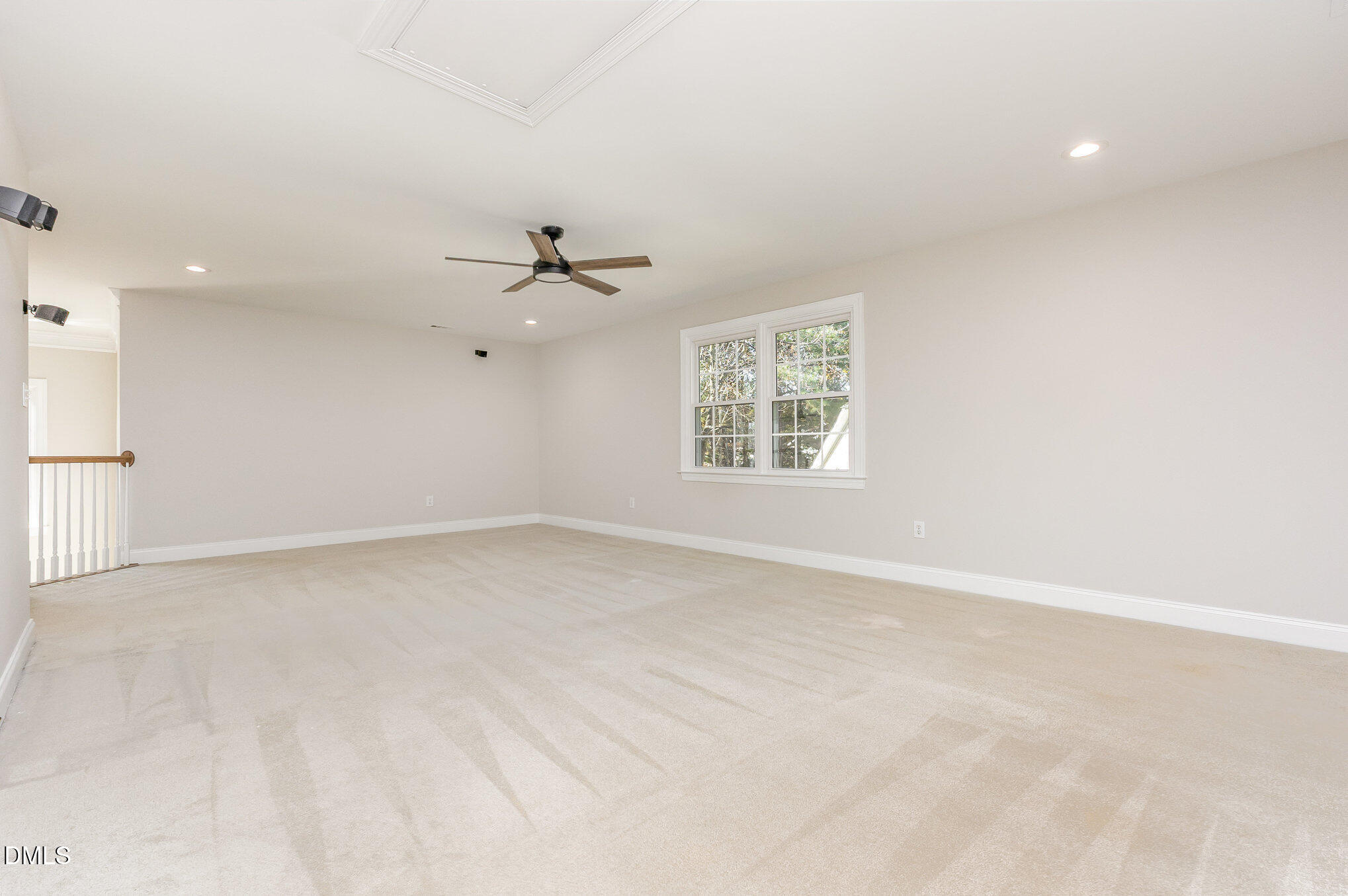 9113 Mission Hills Court Raleigh, NC 27617 - Photo 22 of 36 an empty room with a window and a ceiling fan