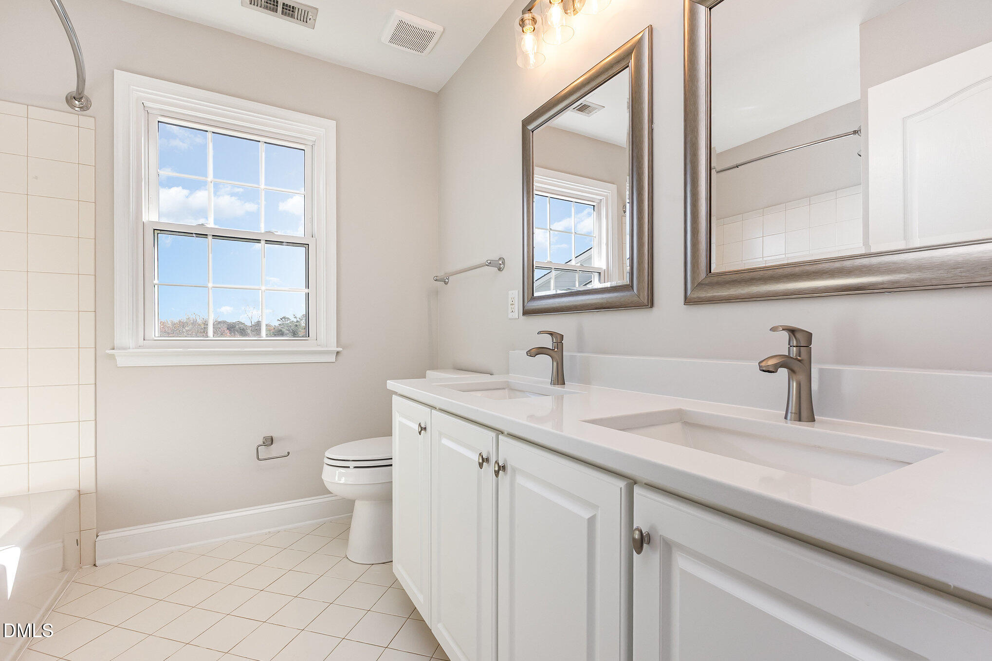 9113 Mission Hills Court Raleigh, NC 27617 - Photo 26 of 36 a bathroom with a granite countertop toilet sink and mirror