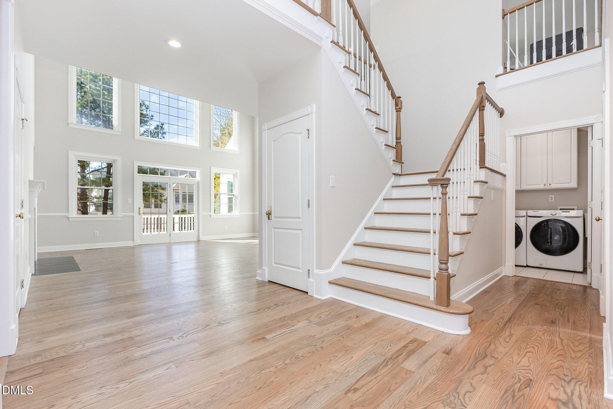9113 Mission Hills Court Raleigh, NC 27617 - Photo 6 of 36 a view of a livingroom with wooden floor and stairs