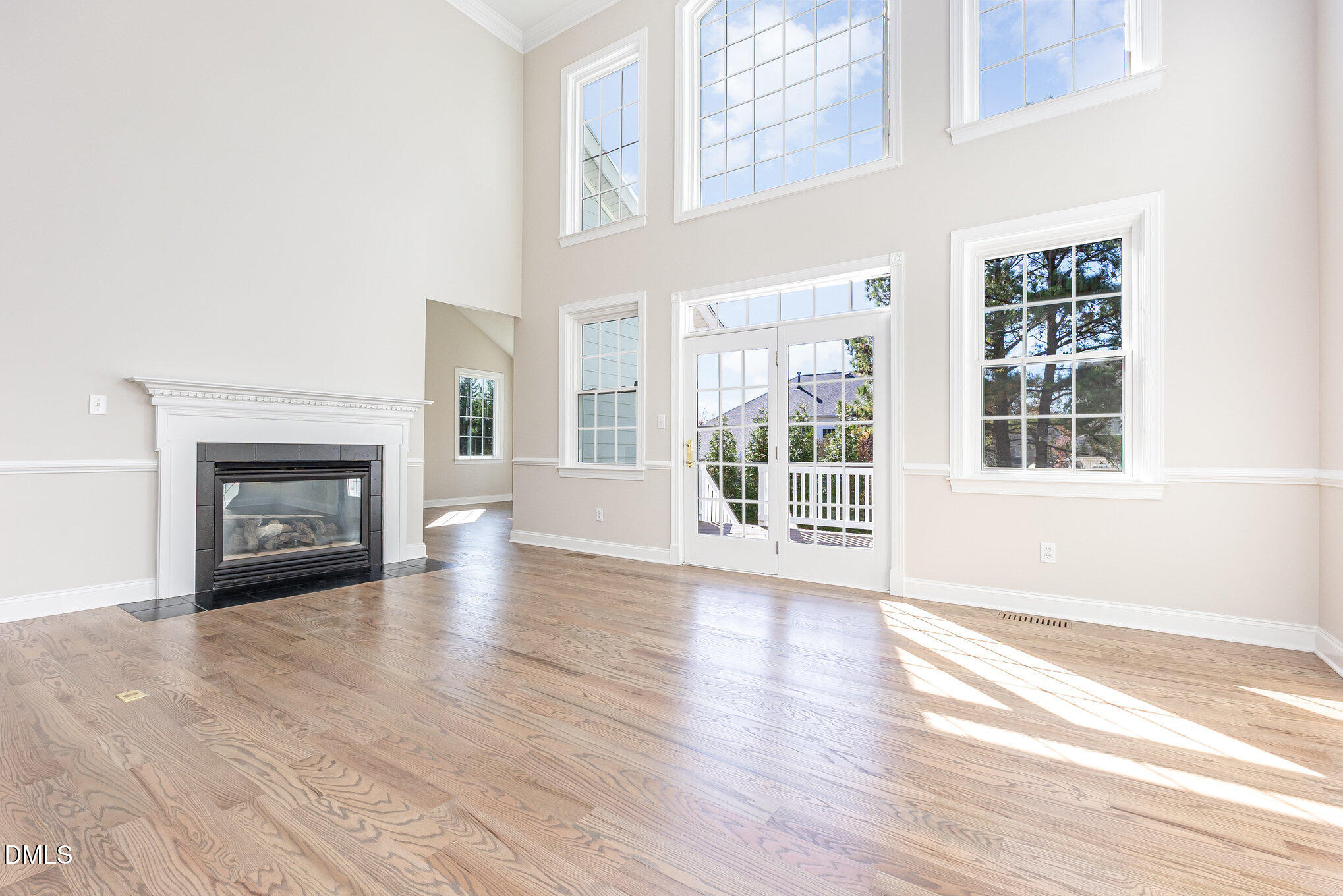 9113 Mission Hills Court Raleigh, NC 27617 - Photo 8 of 36 a view of an empty room with wooden floor and a window