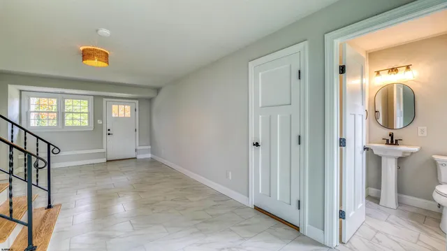 an empty room with wooden floor and mirror