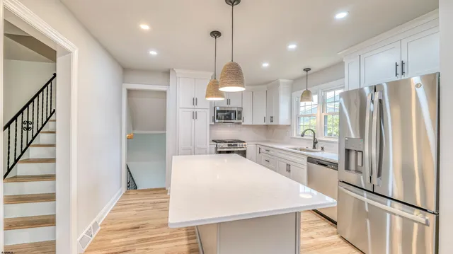 a kitchen with stainless steel appliances a refrigerator sink and stove