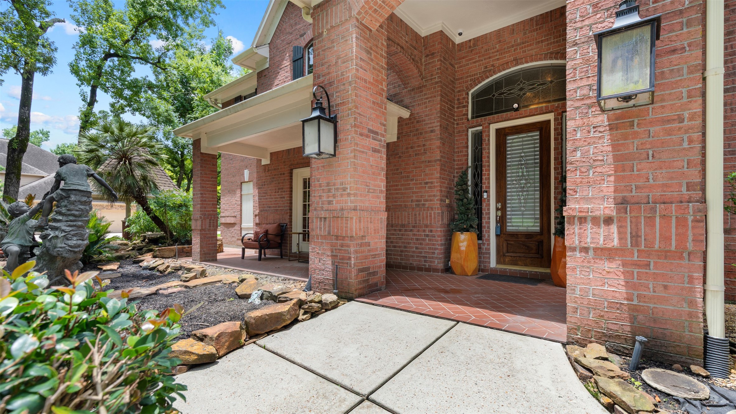 37703 Edgewater Drive Pinehurst, TX 77362 - Photo 8 of 37 a view of a brick house with potted plants