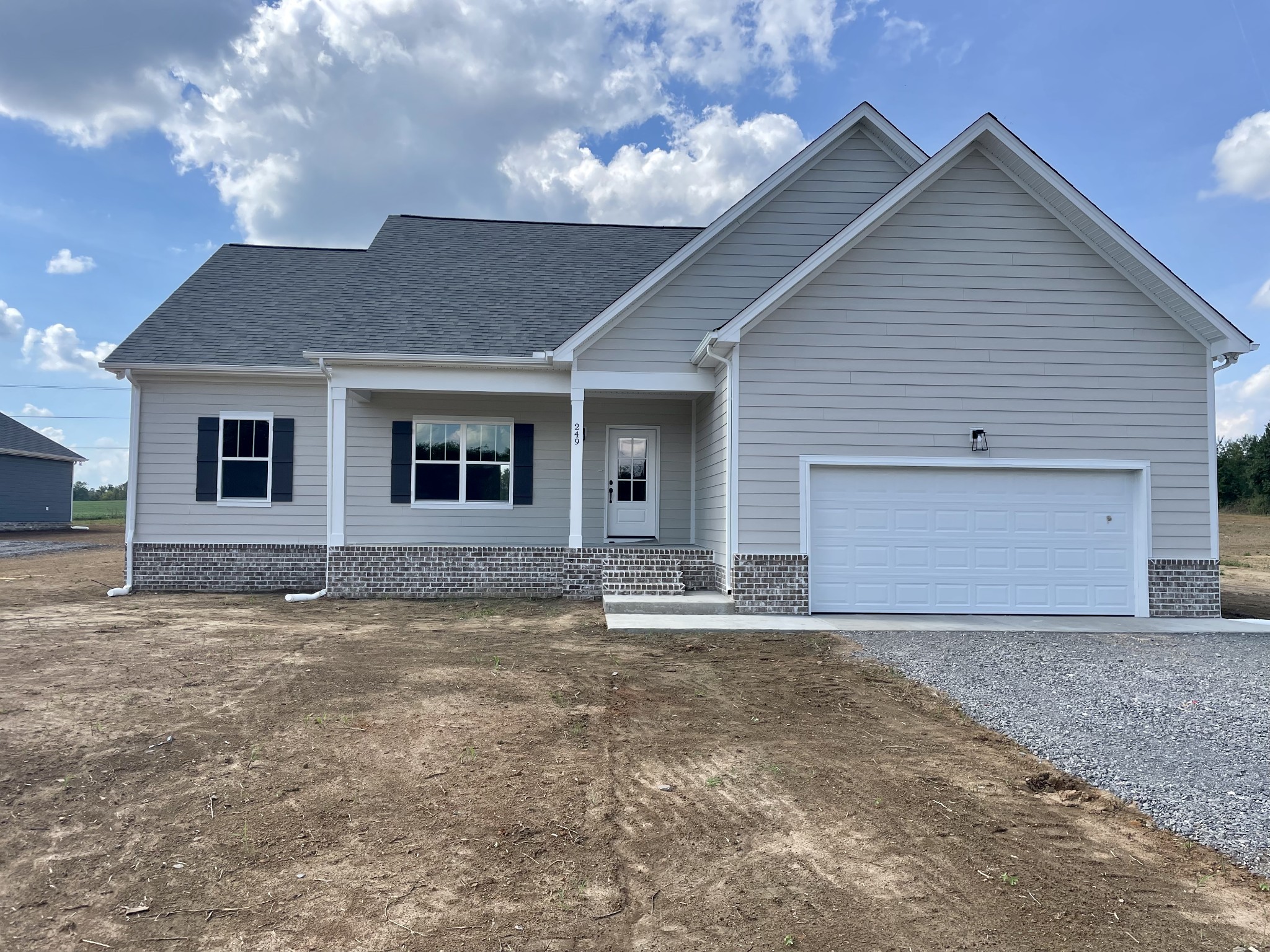 249 Tom Ferrell Road Portland, TN 37148 - Photo 1 of 28 a front view of a house with a yard and garage