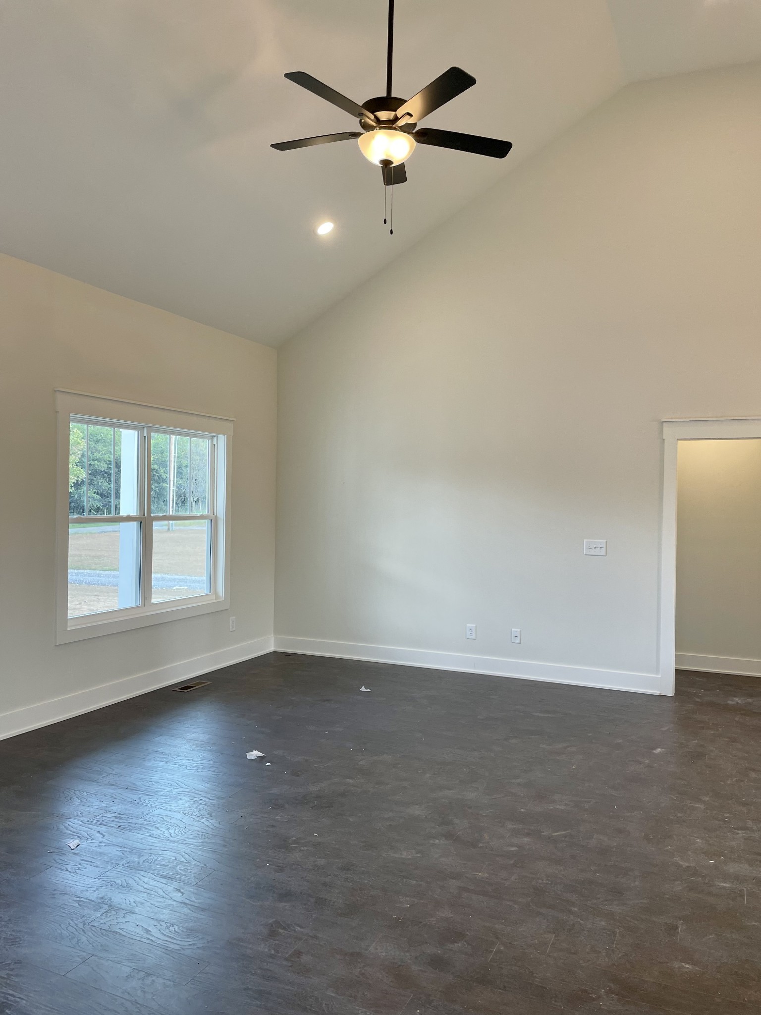249 Tom Ferrell Road Portland, TN 37148 - Photo 12 of 28 an empty room with wooden floor ceiling fan and windows
